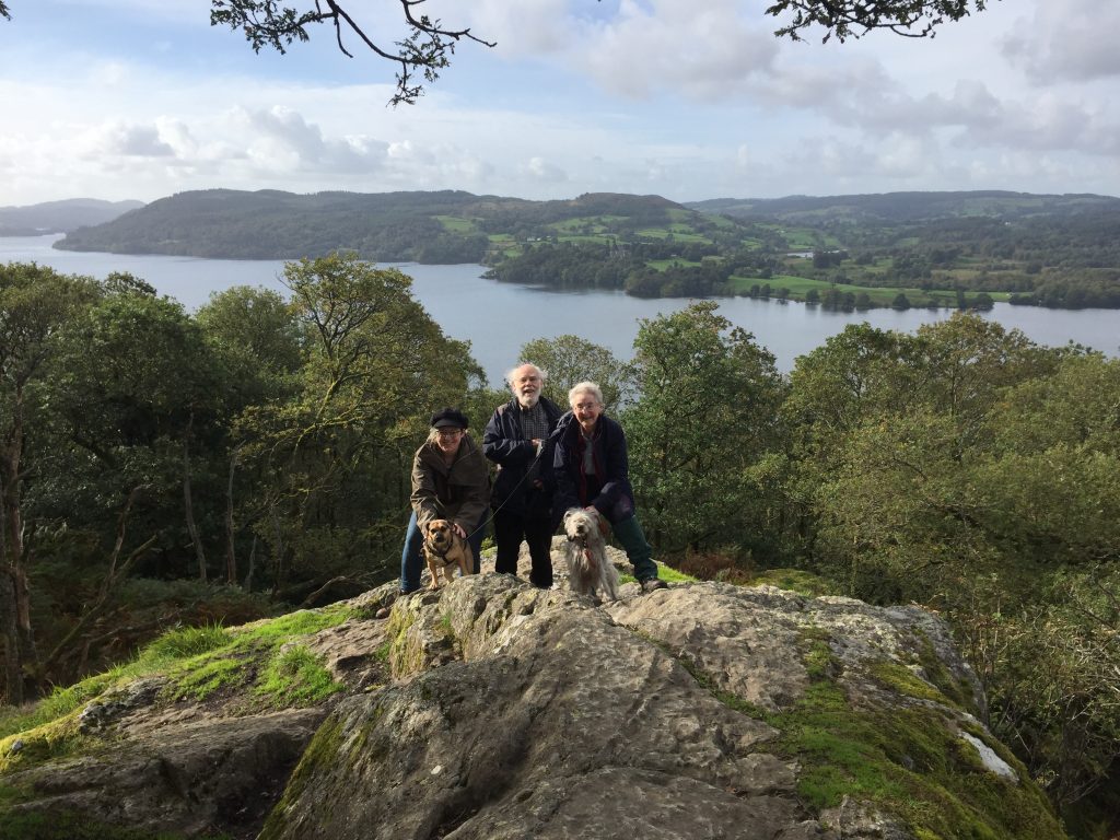 me, my parents and two dogs standing on a cliff edge in the Lake District.